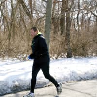 <p>A runner hits the trails at a chilly Greenwich Point Park. </p>