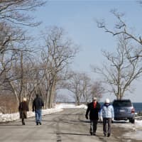 <p>Walkers hit the road, which is cleared of snow and safe for pedestrians. </p>