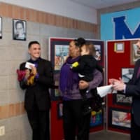 <p>Jacob Maldanado, Biondi School student at Leake &amp; Watts, Maria George and Alan Mucatel unveil a photo of Rita Gross Nelson, the 2015 Black History Month Wall of Fame honoree.</p>