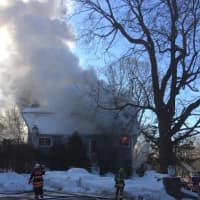 <p>Smoke pours from the fire at 266 Range Road on Saturday. </p>
