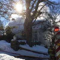 <p>Firefighters attack the blaze at 266 Range Road in Wilton.</p>