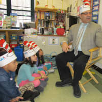 <p>Isaac Young Middle School Principal Anthony Bongo reads a Dr. Seuss selection to a class at Trinity Elementary School in New Rochelle. </p>