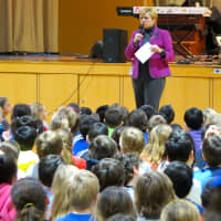 <p>Todd Elementary School Principal Nadine McDermott introduced folk musician Tom Chapin and his band at a special schoolwide assembly on Wednesday, Feb. 4. </p>
