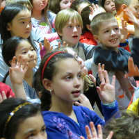 <p>Folk musician Tom Chapin taught Todd Elementary School students how to sing along to the song Family Tree using American Sign Language. </p>