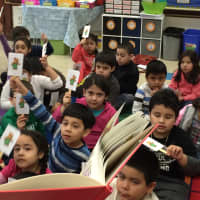 <p>Students in Ms. Lezajas first-grade class use stick puppets as they listen to the book &quot;Corderoy.&quot;</p>