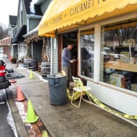<p>A worker repairs the damage at 109 Cheese &amp; Wine in Ridgefield after a car hit the building Wednesday. </p>