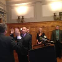 <p>Mayor Mike Spano swears in Commissioner John Darcy as his wife Sherry looks on.</p>