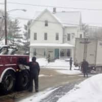 <p>The truck is slowly towed from the intersection of Grand Street, Wilson Street and South Street at about 8:30 a.m. Thursday. </p>