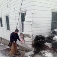 <p>A contractor checks the damage on the house. </p>