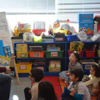 <p>Kathy Storfer reads to a group of kids at Bedford Hills Elementary School.</p>