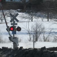 <p>The red lights at a railroad crossing signal for cars to stop.</p>