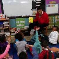 <p>Mount Vernon Superintendent Kenneth Hamilton reading &quot;One Fish, Two Fish, Red Fish, Blue Fish,&quot; to students.</p>