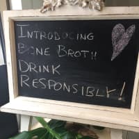 <p>A sign at Ladle of Love invites guests to try bone broth.</p>