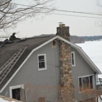 <p>The other side of a fire-damaged home overlooking Lake Mahopac.</p>