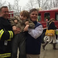 <p>Dan Anderson, chairman of the Darien Fire Department, with Miles and Cyrus after dropping the boys off at the Darien YMCA before the party Tuesday.</p>