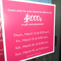 <p>A sign promoting gift card giveaways to celebrate the opening of Saks Fifth Avenue OFF 5TH on Thursday through Sunday mornings.</p>