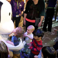 <p>Museum mascot BooZoo gets a warm welcome from visiting children.</p>