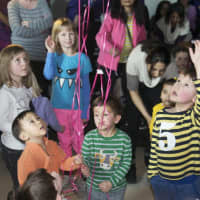 <p>Kids await the spoils from a pinata.</p>