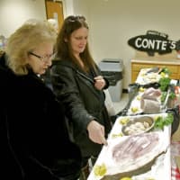 <p>Dean Conte (R) of Conte&#x27;s Fish Market in Mount Kisco helps customers at the Farmer&#x27;s Market.</p>