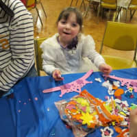 <p>Arts and crafts time for the children as Zeesy Hurwitz is making a crown for Purim.</p>