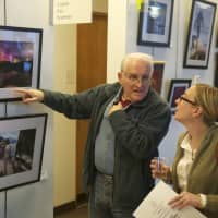 <p>Visitors view photos at the Wilton Arts Council exhibit.</p>