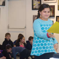 <p>A student goes to the front of the room to receive </p>