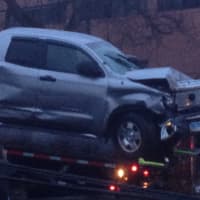 <p>The damaged truck is towed away.</p>