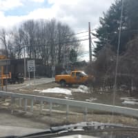 <p>State Department of Transportation vehicles near the Commerce Street railroad crossing next to the Taconic State Parkway on Wednesday afternoon.</p>