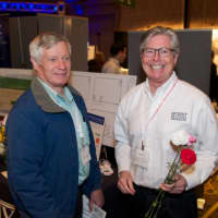 <p>Michael Murphy, right, of Murphy Brothers Contracting was giving away flowers.</p>