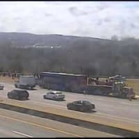 <p>A wrecker begins to tow the bus from the shoulder of I-84. </p>