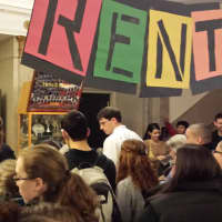 <p>Josh Tenzer, drama coach and special education teacher at Port Chester High School, greets parents Thursday evening streaming into the opening night of &quot;Rent.&quot;</p>