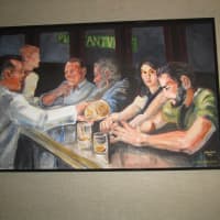 <p>Paintings hang on the wall at the Iron Horse Pleasantville.</p>