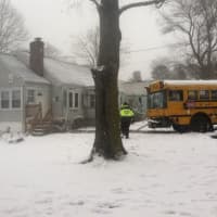 <p>The school bus slammed into the porch of the house at the left. </p>