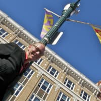 <p>Jon Campbell with some of his banners near Main Street in Stamford.</p>
