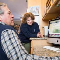 <p>Richard and RosAnne Hubli of Wilton track energy savings resulting from going solar.</p>