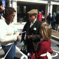 <p>Former longtime chairman of the Greenwich St. Patrick&#x27;s Day parade John Halpin speaks with a couple of paradegoers Sunday.</p>