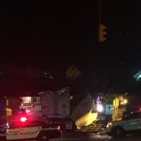 <p>A tractor-trailer is wedged under a Metro-North train bridge in the center of Darien on Sunday night. </p>