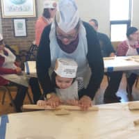 <p>Yonkers residents, Iris and her daughter Emily are having fun rolling the dough for their very own matzoh.</p>