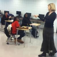<p>Catherine Brackett leads a &quot;College Forum&quot; class at Wright Technical High School. The Grade 9 students earn a free NCC credit once they complete it successfully.</p>