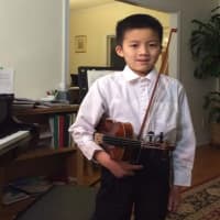 <p>Joning Wang plays the violin.</p>