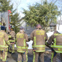 <p>Brewster firefighters prepare to leave after responding to a residential fire at a home overlooking Tonetta Lake.</p>