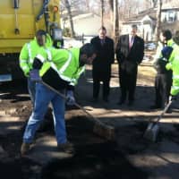 <p>City workers, from left, Hanlet Castillo, Aaron Turner, and Joseph Coplon, clean out a pothole before its filled with hot asphalt as Mayor David Martin looks on. March 31-31 has been dubbed &quot;Pothole Week&quot; by the city.</p>