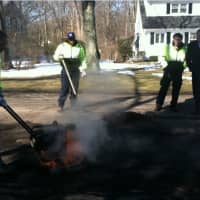 <p>Hanlet Castillo presses hot asphalt into place as from left, Joseph Coplon, Tom Turk and Mayor David Martin look on. The city has declared March 23-31 Pothole Week and is encouraging residents to call the city to report potholes.</p>