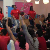 <p>Brookside Elementary students in Norwalk raise their hands in a talk with students from HEART.</p>