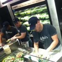 <p>Workers busily prepare salads at the special opening of Chop&#x27;t on Wednesday. Proceeds from the meals were given to a Greenwich-based charity. </p>