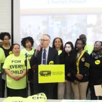 <p>Bruce Ravage, at the microphone, leads a charter school rally Thursday in Bridgeport. </p>