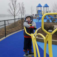 <p>Five-year-old Mason Avery of Greenwich checks out the playground equipment at the new Cos Cob Park.</p>