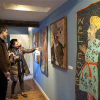 <p>Visitors check out the needle work of June Myles.</p>