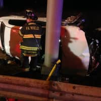 <p>Fairfield and Westport firefighters work together to help victims in a car rollover on I-95. </p>