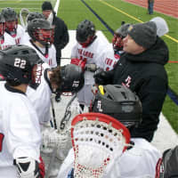 <p>Coach Chris Coughlin talks to his players during a timeout. </p>